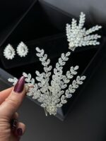 Jewelry held by a woman in her hand.